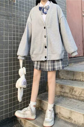 Suéter tipo cárdigan informal holgado con botones en colores básicos