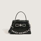 Bolso con asa y cadena con lazo de cristal y estampado animal - Negro