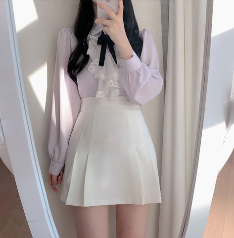 Blusa elegante con volantes y pajarita 