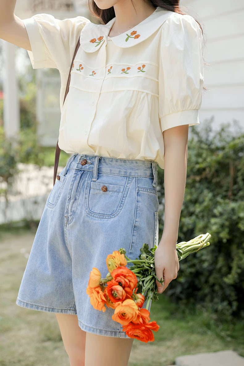 Blusa bordada con gerberas naranjas