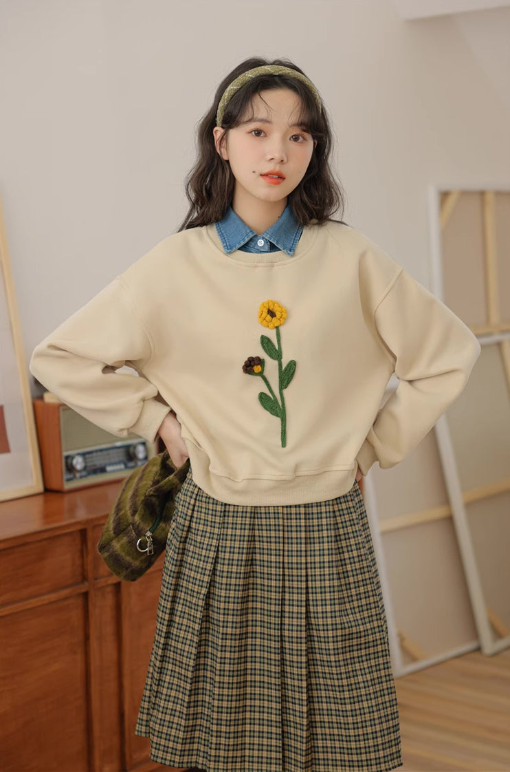 Sudadera con pompones y flores silvestres