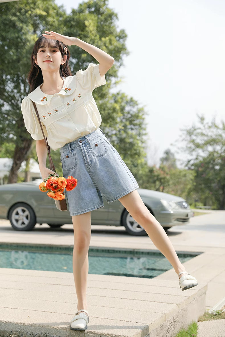 Blusa bordada con gerberas naranjas
