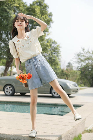 Blusa bordada con gerberas naranjas