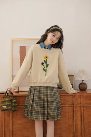 Sudadera con pompones y flores silvestres