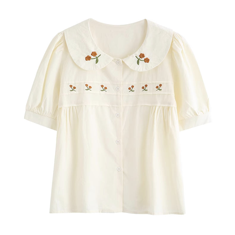 Blusa bordada con gerberas naranjas