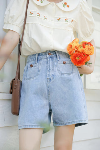 Blusa bordada con gerberas naranjas