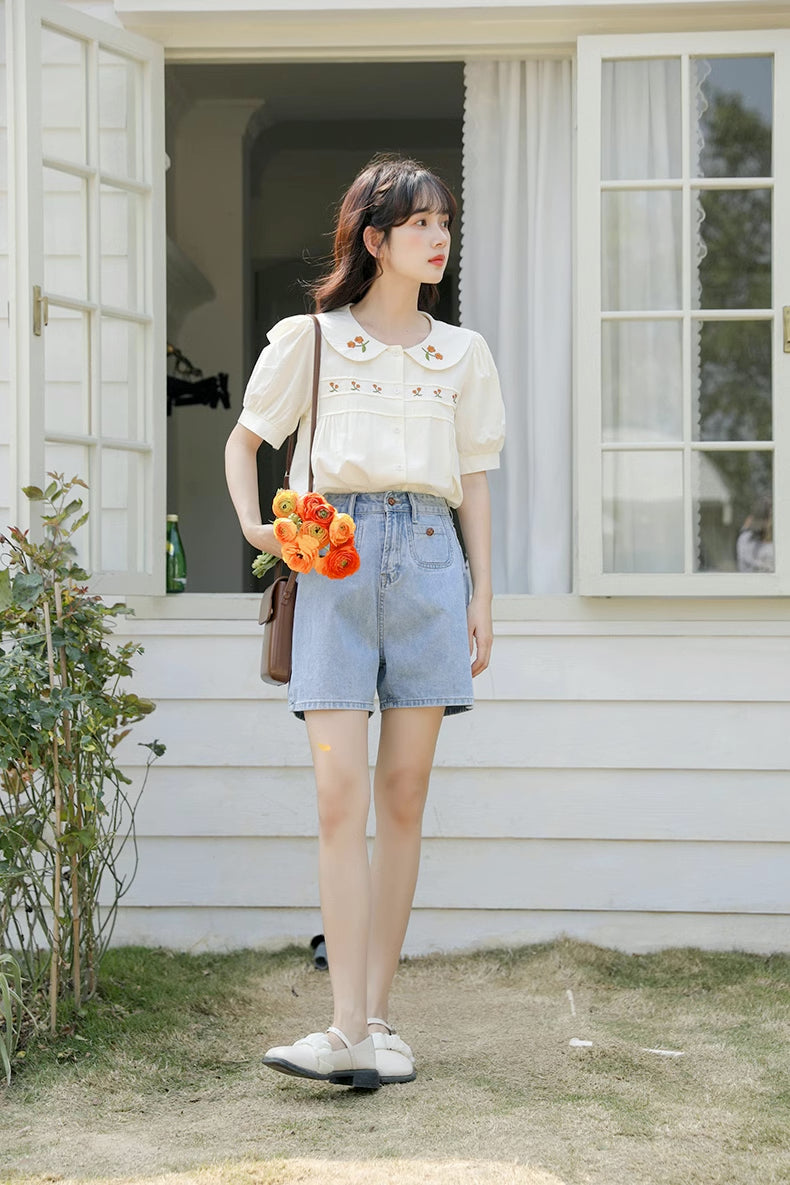 Blusa bordada con gerberas naranjas