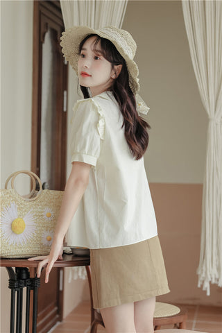 Blusa de manga corta con cadena de margaritas