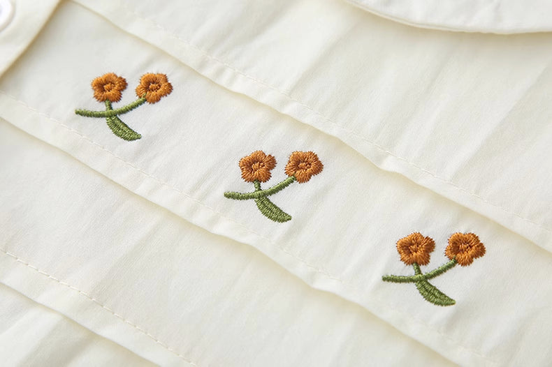 Blusa bordada con gerberas naranjas