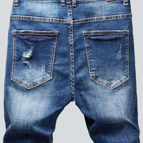 Destroyed blue jeans for men